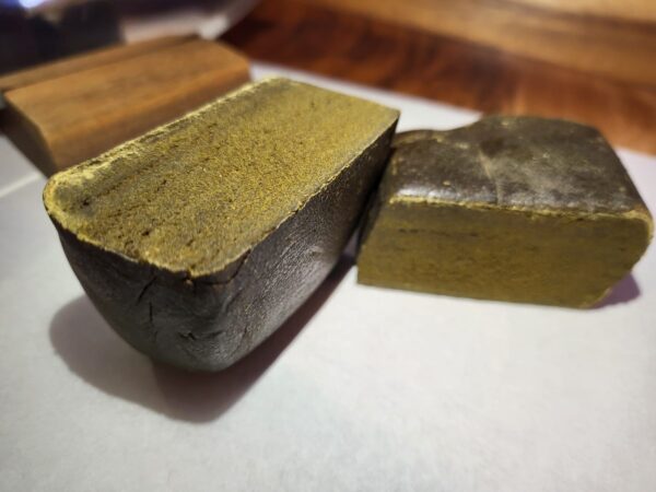Lifter CBD Hashish cut open town pieces with knife in background